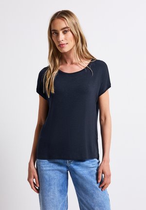 Dark navy short-sleeve t-shirt in a soft, lightweight fabric with a rounded neckline and relaxed fit, paired with light blue jeans.