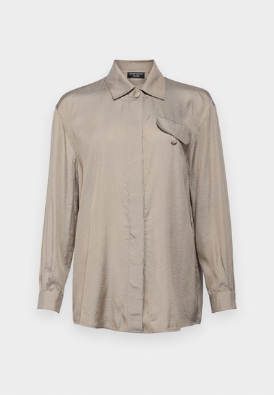 Long-sleeve button-up shirt in metallic beige with fine vertical stripes, featuring a collar and a single chest pocket. Smooth texture.