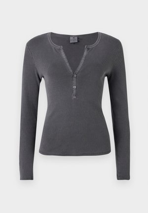 Long-sleeved, dark grey ribbed top with a V-neckline, three-button placket, and fitted design. Soft, smooth texture with minimal stitching.