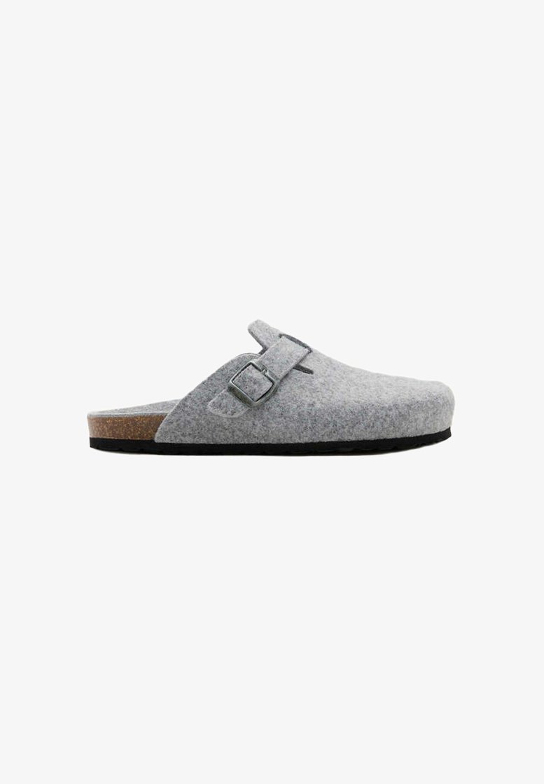 Sabot en feutre gris clair à enfiler avec bride à boucle réglable, semelle intérieure en liège et semelle noire, présenté de profil sur fond blanc.