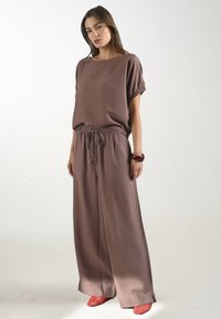 Bruine textuur top met losse mouwen, gecombineerd met bijpassende hoog-waisted wijde broek, met een elastieken tailleband en trekkoord.