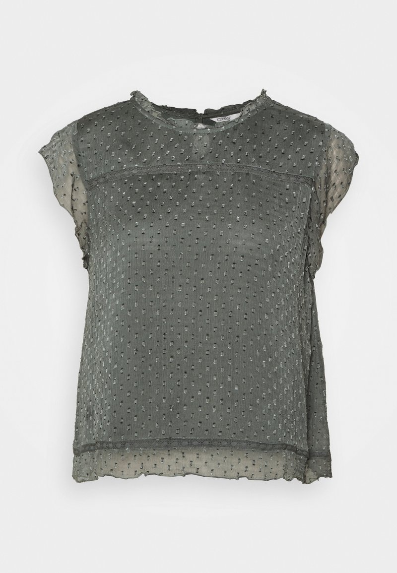 Haut gris à manches courtes en tissu texturé avec des points en relief. Il possède un col rond et un ourlet en couches, transparent.