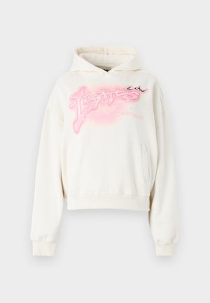 Cream-colored cropped hoodie made of soft fabric. Features a pink graphic design and a front pocket. Includes a drawstring hood and ribbed cuffs.