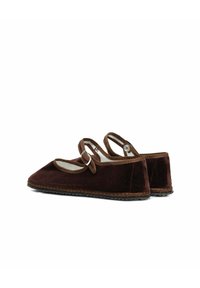 Bruine fluwelen schoenen met een puntige neus en een band over de wreef, met een gestructureerde zool en contrasterende stiksels langs de rand.