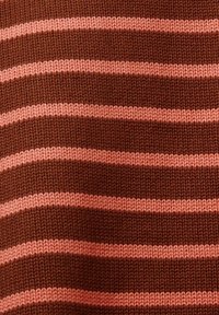 Gros plan sur un tissu tricoté avec des rayures horizontales en fils alternés rose clair et marron.