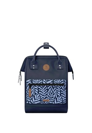 Dunkelblauer Rucksack mit oberen Griffen, vordere Reißverschlusstasche mit blau-weißem Blattmuster und braunen Leder-Brandpatches.