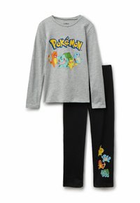 Graues Langarmshirt mit buntem Pokémon-Graphic; schwarze Leggings mit kleinen Pokémon-Drucken an der unteren Beinpartie. Baumwollmischgewebe.