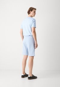 BOSS HEADLO - Spodnji deli trenirk - light blue