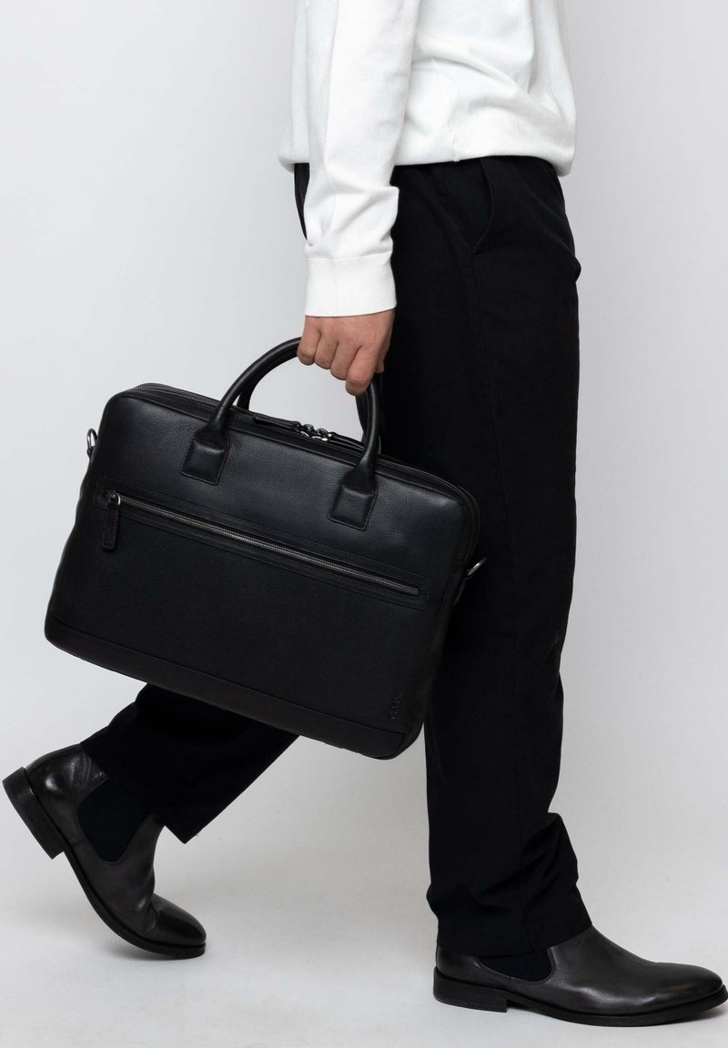 Black leather briefcase with dual handles and a front zipper pocket. Structured design, smooth texture, and minimal accents.