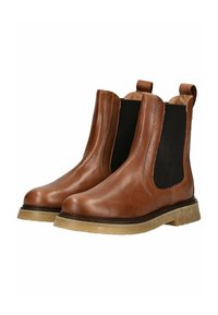 Bottines Chelsea en cuir marron avec panneaux élastiques sur les côtés, semelles en caoutchouc beige et languettes pour un enfilage facile. Texture lisse, design classique.