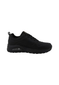 Chaussure de sport noire avec un matériau supérieur lisse, un design à lacets, une semelle intermédiaire rembourrée et une unité d'air visible dans la semelle.