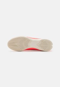 Shoe sole with a textured pattern, featuring a pink upper and a durable off-white rubber sole, designed for traction and stability.