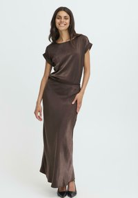 Ruda satino maksi suknelė su laisvu kirpimu, trumpomis rankovėmis, apvalia iškirpte ir diržo juosta. Derinama su juodais aštriais bateliais.