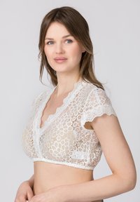 Weiße Spitzenbralette mit kurzen Ärmeln, floralem Muster, gewellten Kanten und V-Ausschnitt. Halbtransparent mit elastischem Saum.