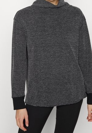 Zwart-witte gestructureerde longsleeve top met een cowl halslijn en zwarte accenten bij de manchetten, gemaakt van een zachte, gebreide stof.