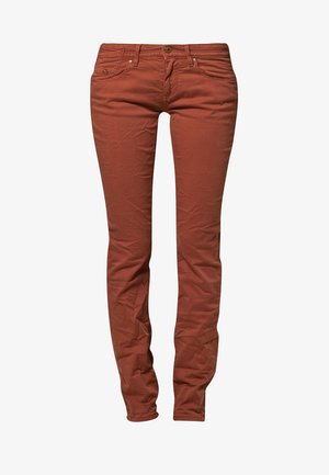 Rust-colored skinny jeans made of cotton blend fabric, featuring five-pocket design and a front button closure. Textured with slight creasing.