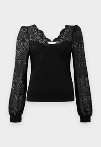 Black top featuring a lace front with a scalloped neckline, long sheer lace sleeves, and smocked cuffs for texture.