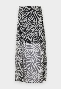 Jupe midi transparente à motif feuilles noir et blanc, avec doublure partielle et taille élastique, présentée sur fond uni.