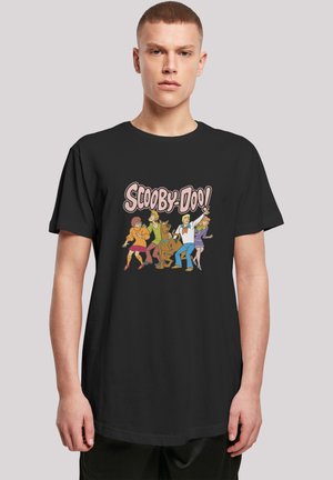 Svart bomull t-skjorte med et fargerikt grafisk trykk av tegneseriefigurer fra "Scooby-Doo" på forsiden. Korte ermer, rund hals.