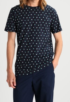 Marineblå kortærmet t-shirt med et mønster af små teal og hvide cirkler. Lavet af blød bomuld med en rund halsudskæring.