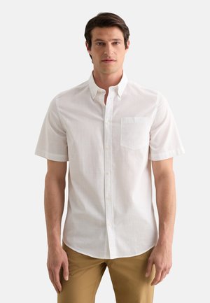 Camisa blanca de manga corta con botones y un solo bolsillo en el pecho, hecha de una tela ligera, con un cuello clásico y una textura sutil.
