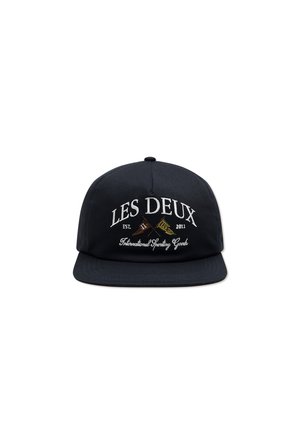 Black snapback cap made of cotton, featuring white embroidered text “LES DEUX” and a logo with sporting goods accents. Flat brim design.
