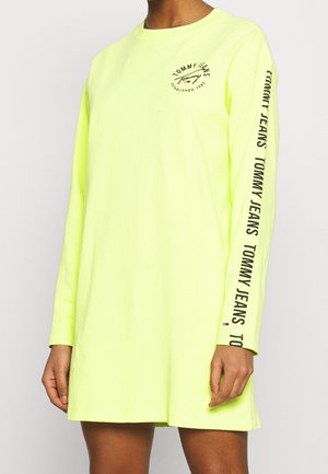 Langermige, neongele shirt van katoen. Voorzien van het "TOMMY JEANS" logo op de voorkant en de mouw. Ontspannen pasvorm met ronde halslijn en eenvoudige zoom.