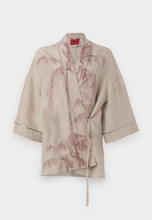 Beige kimono-style wrap top in lightweight fabric, featuring a pink palm tree print and a tie closure at the waist, with wide sleeves.