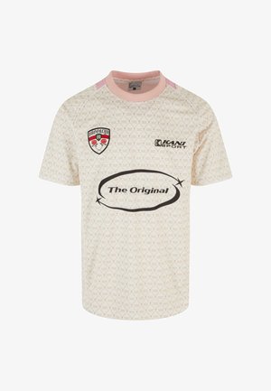 Heled roosa ja kreemika mustriga džersikangas, ümmarguse kaelusega, lühikeste varrukatega, tekst "The Original" ning vapp, millel on roosid ja sõna "BROOKLYN."