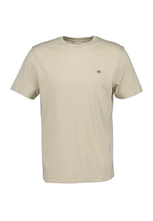 T-shirt beige à manches courtes avec col rond, petit emblème brodé sur la poitrine gauche, devant uni et coupe régulière.