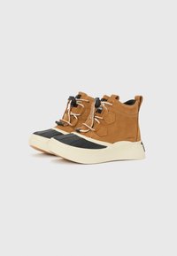 Brown suede ankle-height sneakers with black rubber toe, textured sole, and contrasting white laces. Features waterproof accents and branding.