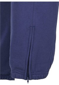 Dunkelblaues Sweatshirt mit einer Reißverschlusstasche am Saum. Verfügt über gerippte Bündchen und elastische Kanten für eine bequeme Passform. Aus weichem Stoff gefertigt.