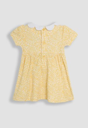 Sárga ruha virágmintával, rövid ujjakkal és fehér Peter Pan gallérral. Hátul gombokkal záródik. Puha anyag, bővülő szoknya.