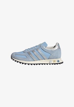 Light blue suede running shoe with silver accent stripes, a textured rubber outsole, and a cushioned sole for traction and comfort.