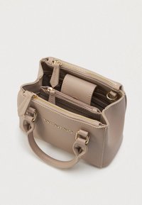 Tan leather handbag with gold hardware, dual top handles, and zippered compartments. Features a smooth texture and embossed brand logo.