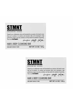STMNT Grooming Goods Hair & Body Cleansing Bar packaging with brand statement, signatures, and net weight 4.4 oz / 125 g, in black text on white background.