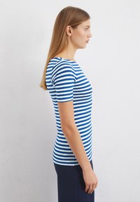 Striped blue and white short-sleeve fitted t-shirt, made from a soft fabric with a round neckline and a smooth texture.