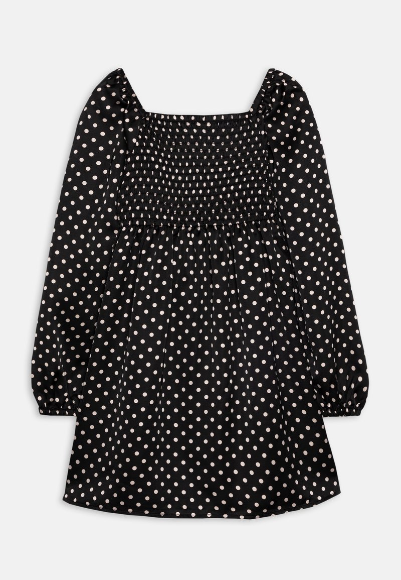 Robe noire avec manches longues bouffantes et encolure carrée. Caractérisée par un corsage smocké et une jupe évasée, ornée de pois blancs.