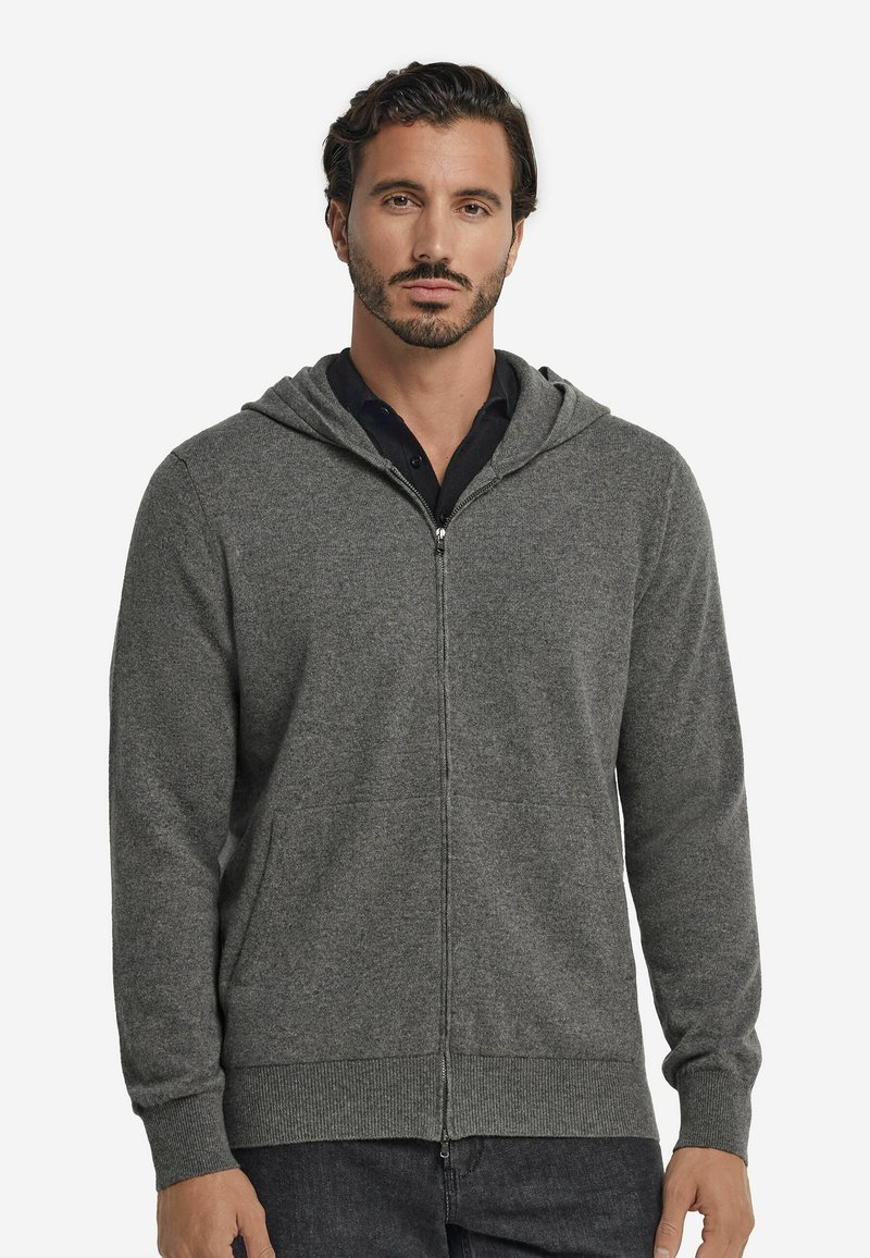 Grå zip-up hoodie med huva, tillverkad av texturerad tyg, som har sidofickor och ribbade muddar vid handlederna och nederkanten.