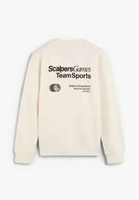 Krämfärgad sweatshirt med tryckt text på baksidan: "ScalersGames Team Sports," en basketballikon och skötselinstruktioner.