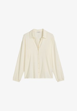 Crème-kleurige blouse met lange mouwen, een kraag, een knoopsluiting aan de voorkant en een iets losse pasvorm. Zacht, glad materiaal met manchetmouwen.
