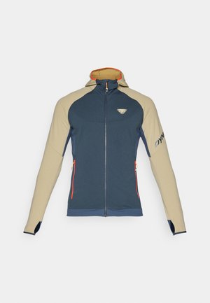 Blå og beige zip-up jakke med hette, med oransje detaljer, to sidelommer og en logo på brystet og ermet.