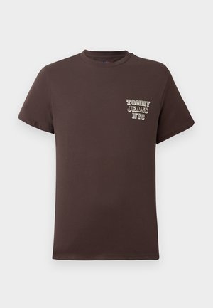 Brown cotton t-shirt with short sleeves. Features a small front print reading "TOMMY JEANS NYC" in white and gold. Classic crew neck design.