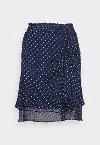 Marinblå prickig kjol med texturerad tyg, rynkade sidodetaljer och lagerkant. Elastisk midja för justerbar passform.