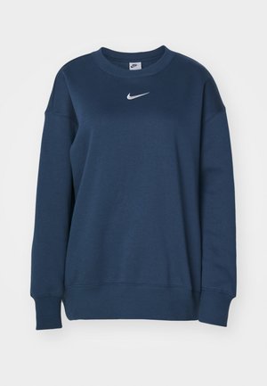 Sudadera de color azul marino con mangas largas, puños y dobladillo acanalados, que presenta un logo blanco de Nike en el centro del pecho. Textura de tela suave.