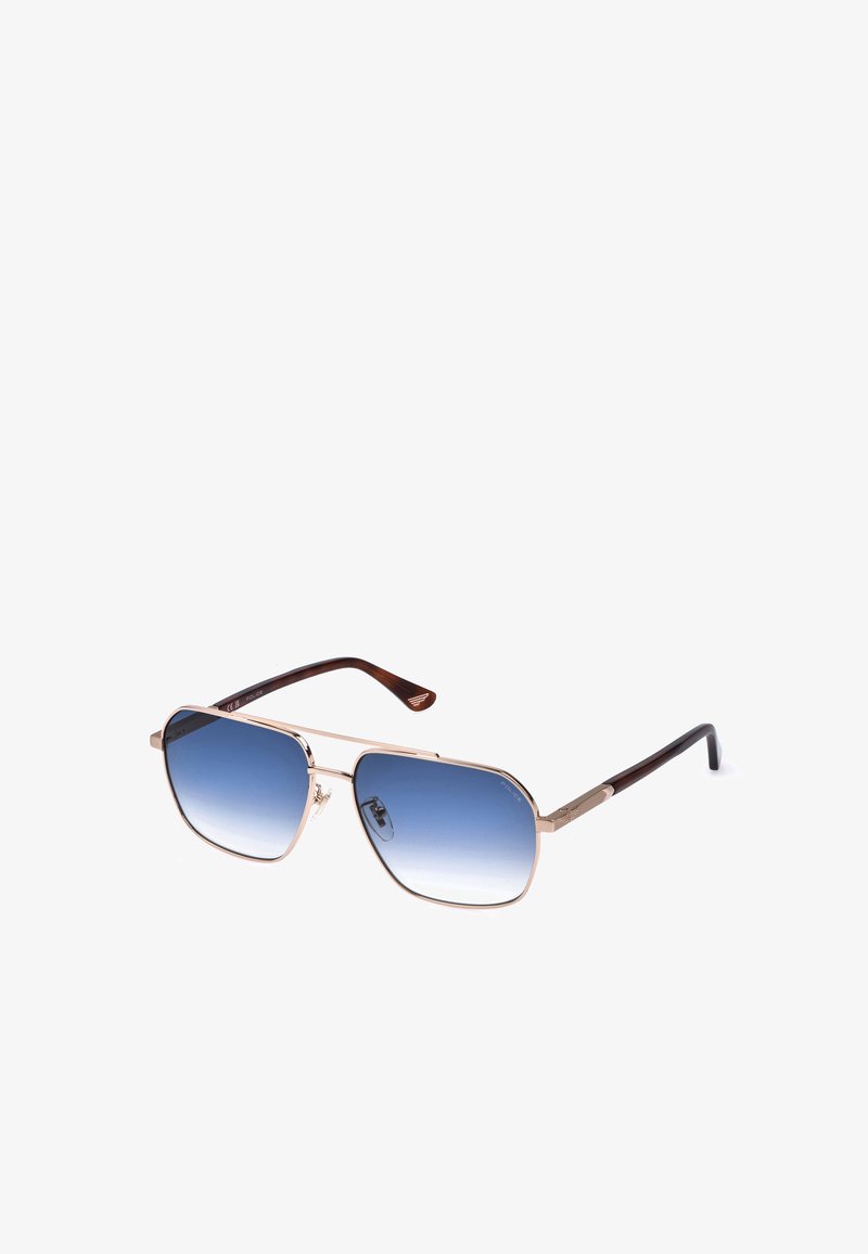 Lunettes de soleil rectangulaires avec fines montures métalliques dorées, branches marron et verres dégradés bleus sur fond blanc.