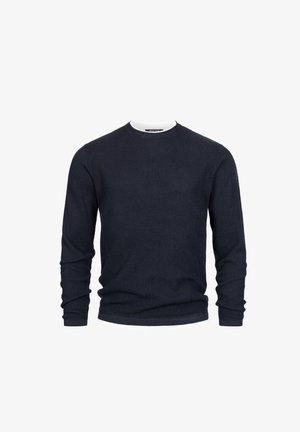 Navy ribbed sweater with long sleeves and a round neckline, featuring a white inner collar for contrast. Made from textured knit material.