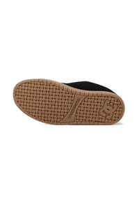 Črna podplat skate čevlja z teksturiranim gumijastim oprijemom, ki ima logotip na območju pete in gladko črno zgornji del.