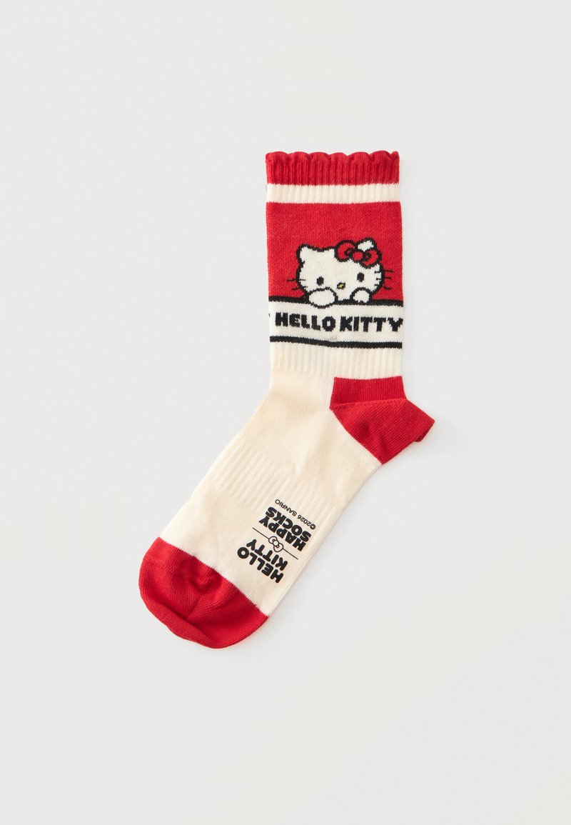 Κρεμ και κόκκινη κάλτσα με το πρόσωπο της Hello Kitty και το κείμενο "HELLO KITTY" στο πάνω μέρος και το λογότυπο "HAPPY SOCKS" κοντά στη σόλα.