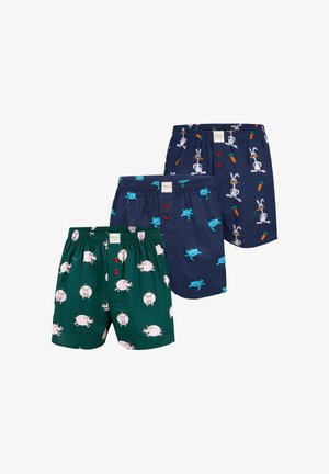 Drie paren herenboxers: groen met varkenspatronen, marineblauw met cartoonkonijnen, en een mengsel van patronen met schildpadden en wortelen, zachte stof, elastische taille.